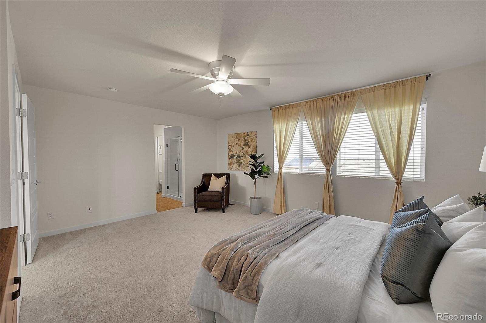 10951 Touchstone Loop Parker, CO 80134 - Photo 20 of 46 a bedroom with a bed and a large window