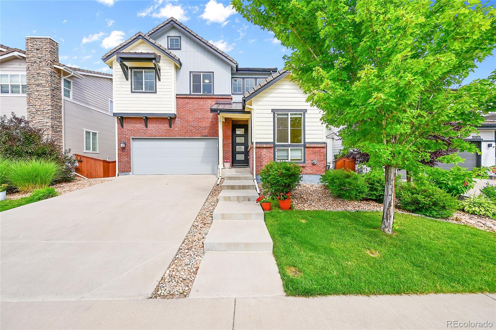 10951 Touchstone Loop Parker, CO 80134 - Photo 2 of 46 a front view of a house with a yard