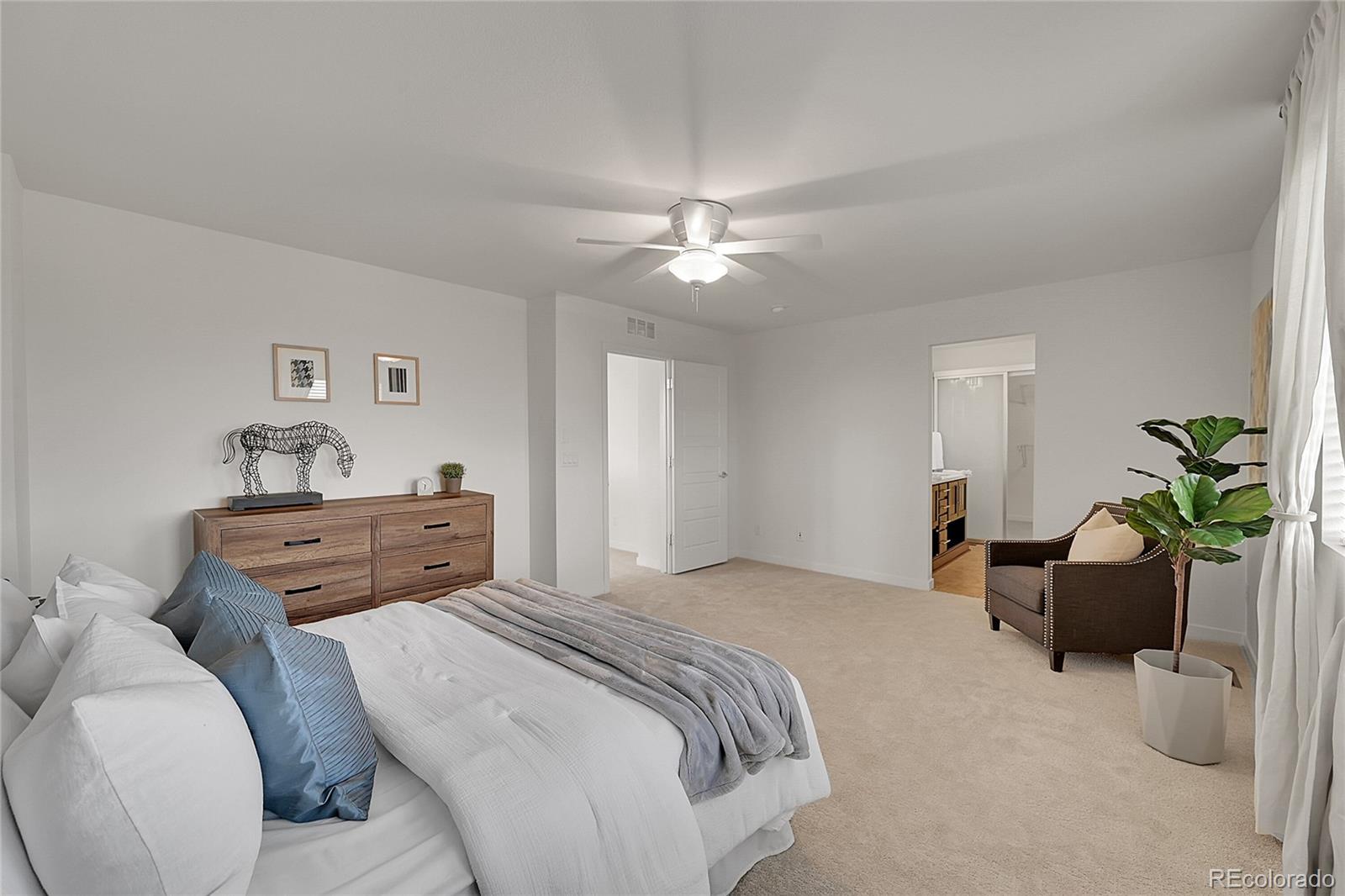 10951 Touchstone Loop Parker, CO 80134 - Photo 22 of 46 a bedroom with a bed and ceiling fan