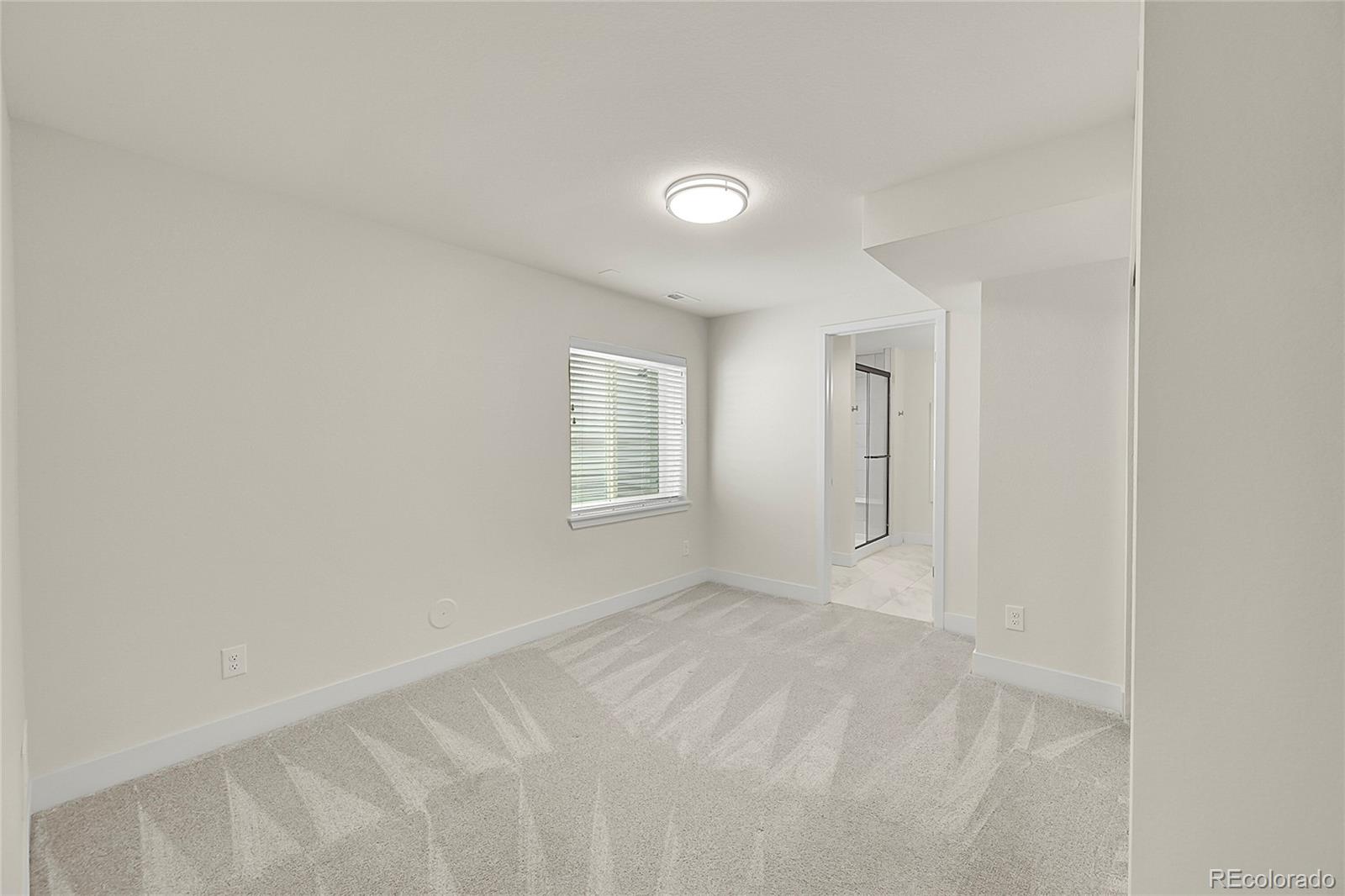 10951 Touchstone Loop Parker, CO 80134 - Photo 29 of 46 a view of an empty room with a window