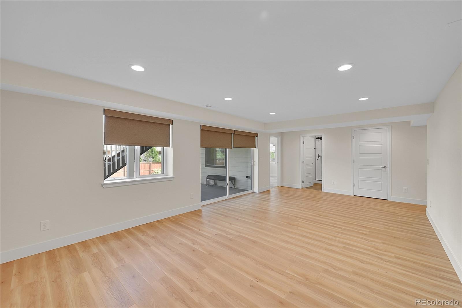10951 Touchstone Loop Parker, CO 80134 - Photo 31 of 46 a view of an empty room with window and wooden floor