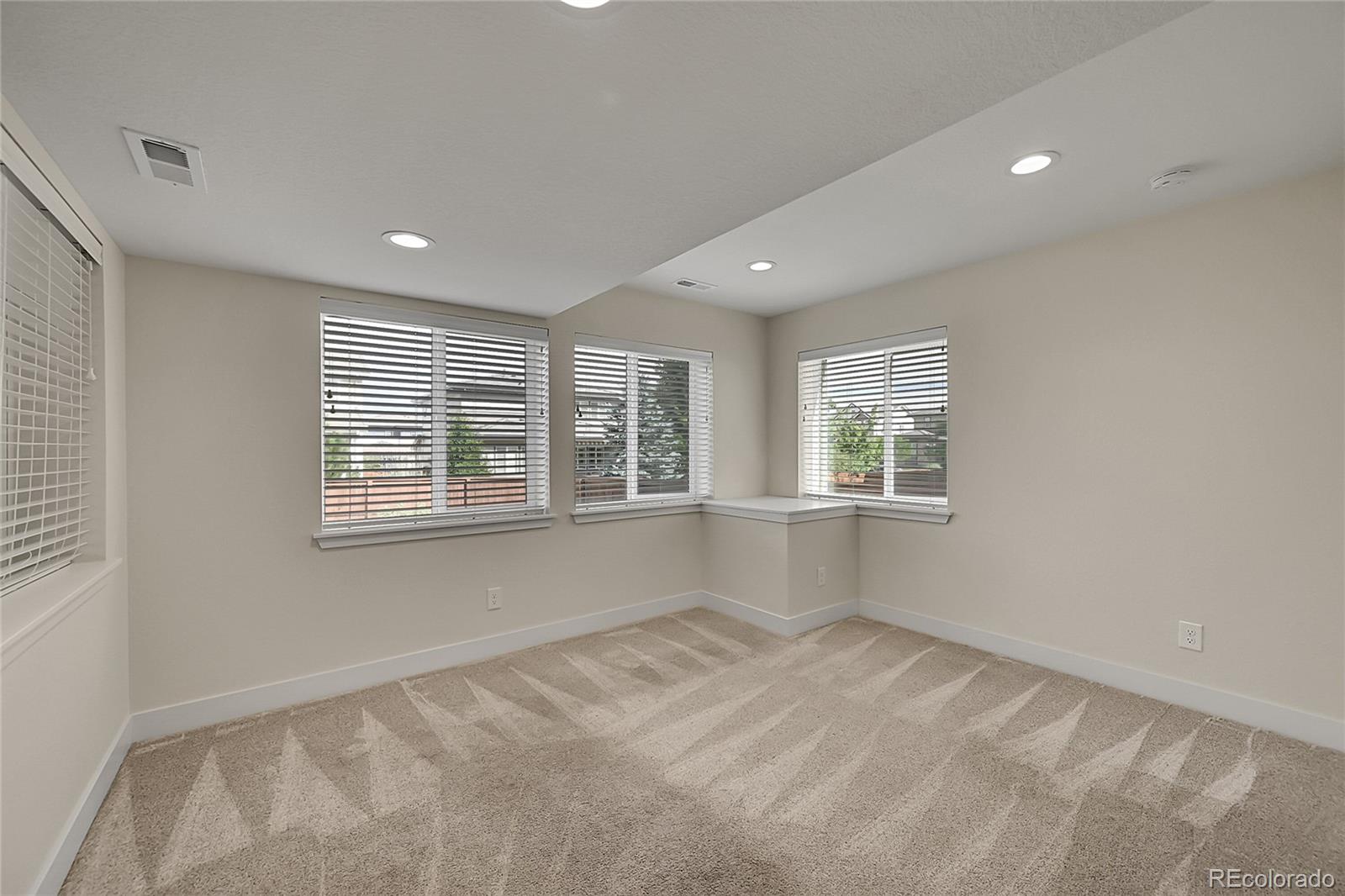 10951 Touchstone Loop Parker, CO 80134 - Photo 32 of 46 a view of empty room with wooden floor and fan