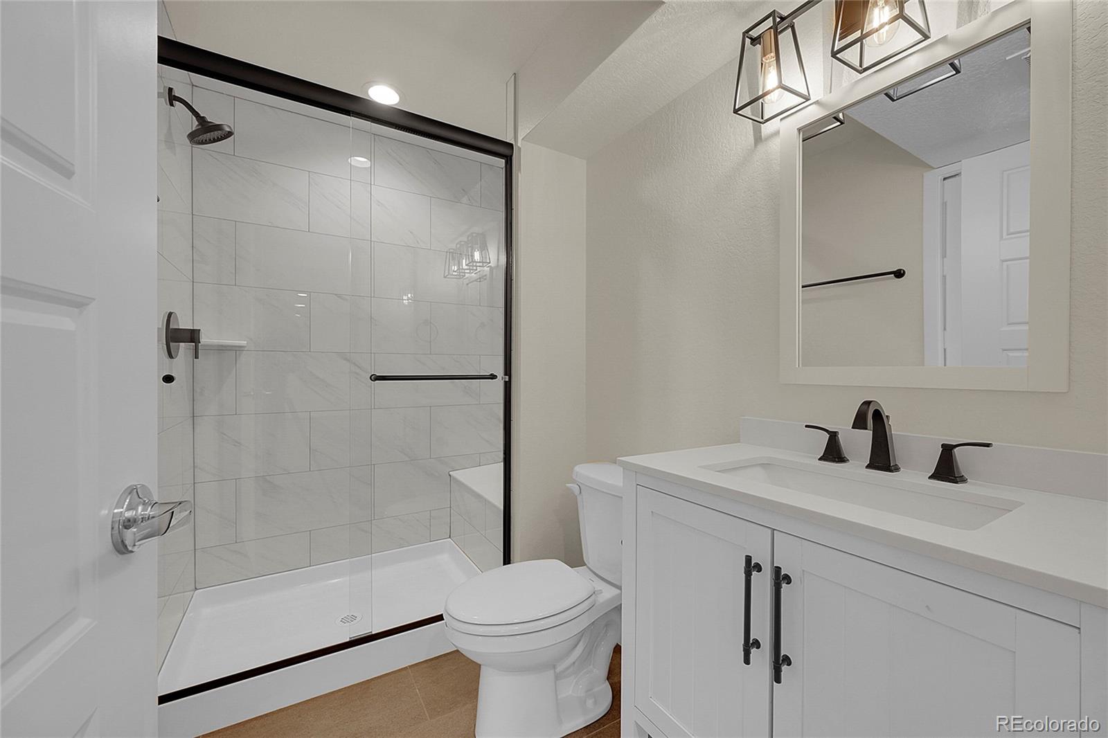 10951 Touchstone Loop Parker, CO 80134 - Photo 33 of 46 a bathroom with a sink toilet and shower