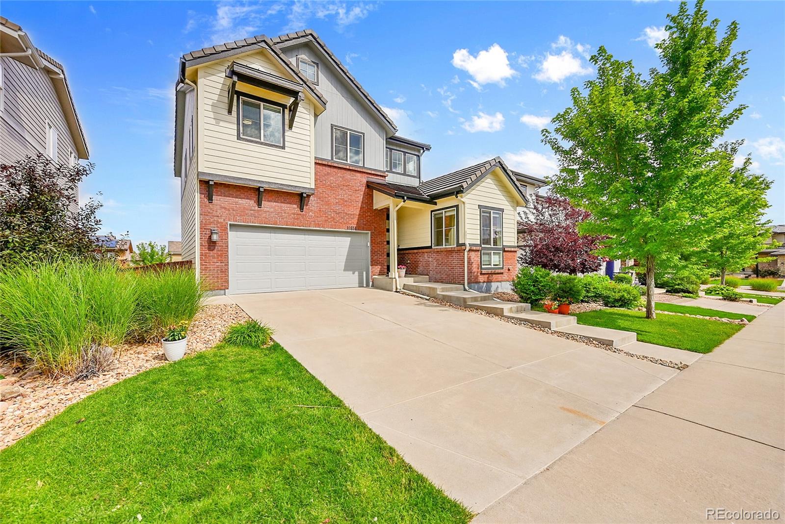 10951 Touchstone Loop Parker, CO 80134 - Photo 38 of 46 a front view of a house with a yard and garage