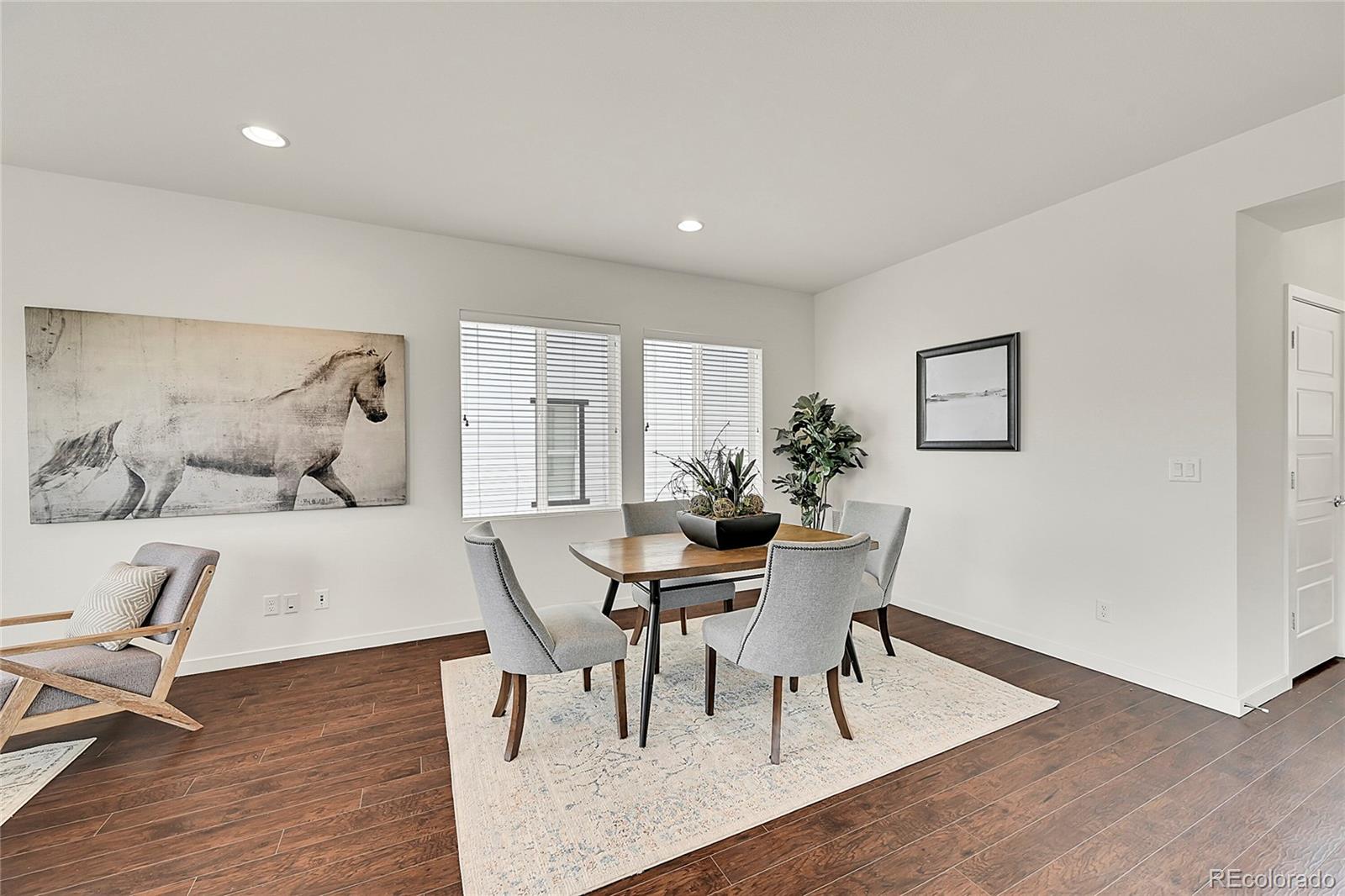 10951 Touchstone Loop Parker, CO 80134 - Photo 4 of 46 a view of a dining room with furniture and wooden floor
