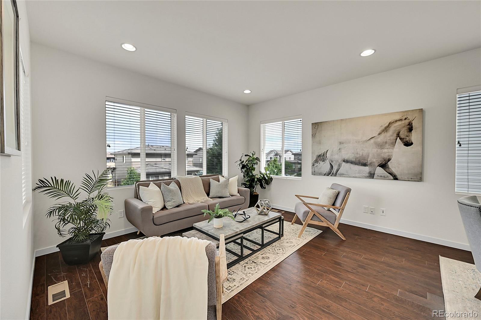 10951 Touchstone Loop Parker, CO 80134 - Photo 5 of 46 a living room with furniture wooden floor and a large window