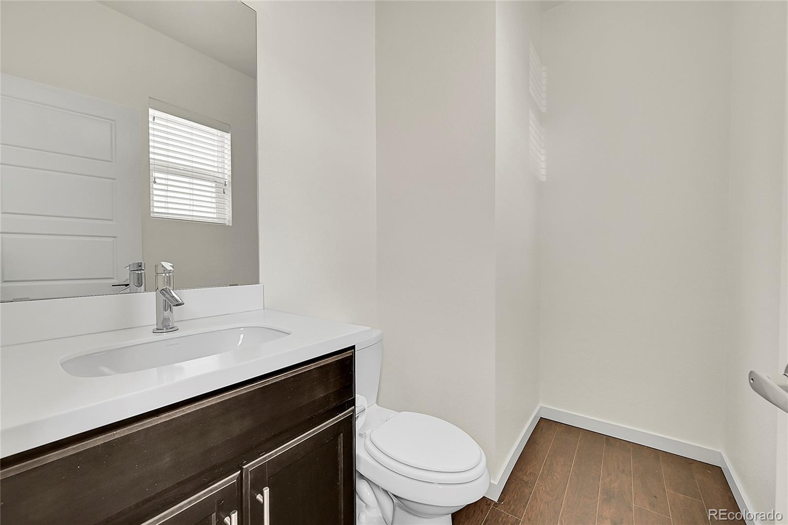 10951 Touchstone Loop Parker, CO 80134 - Photo 9 of 46 a bathroom with a sink toilet and vanity