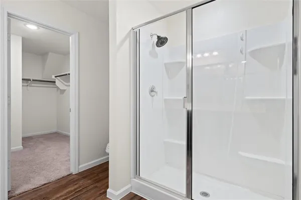 a bathroom with a glass shower door
