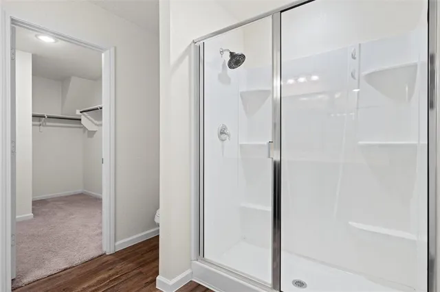 a bathroom with a glass shower door