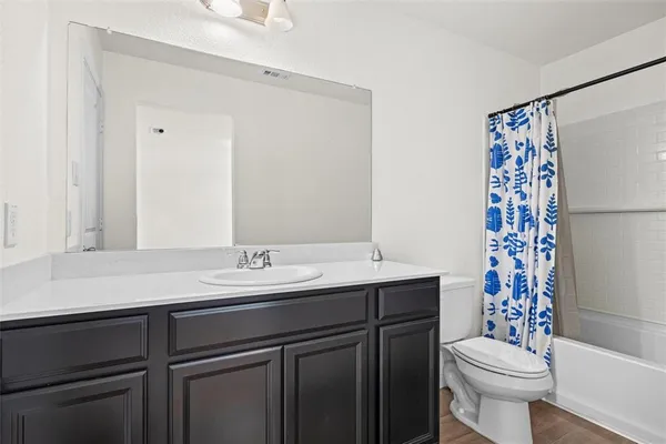 a bathroom with a sink toilet and a mirror