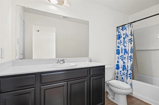 a bathroom with a sink toilet and a mirror
