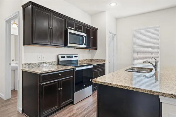 a kitchen with a stove and a microwave