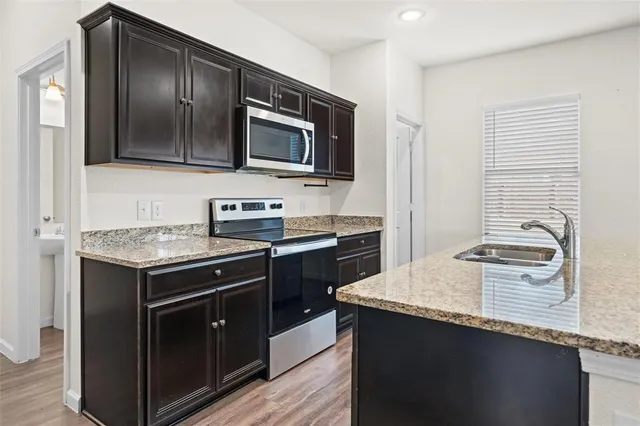 a kitchen with a stove and a microwave