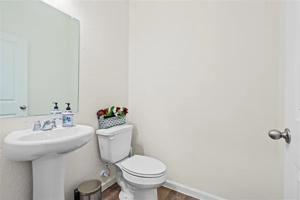 a bathroom with a sink a toilet and a mirror