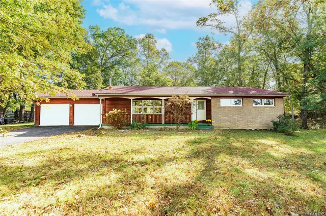 a view of a house with a yard and tree