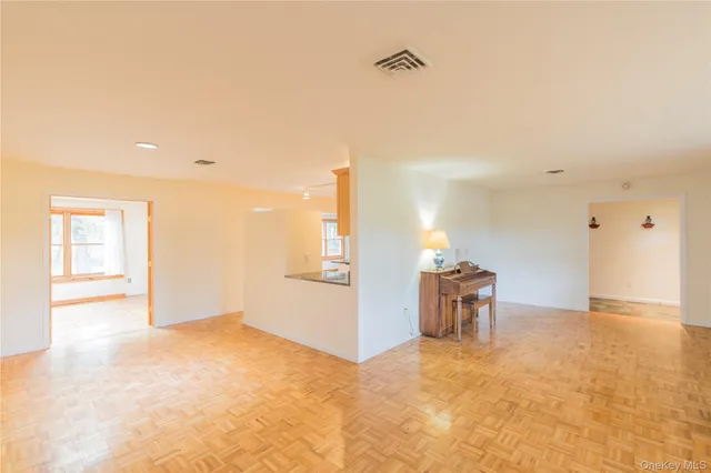 a view of empty room with a kitchen