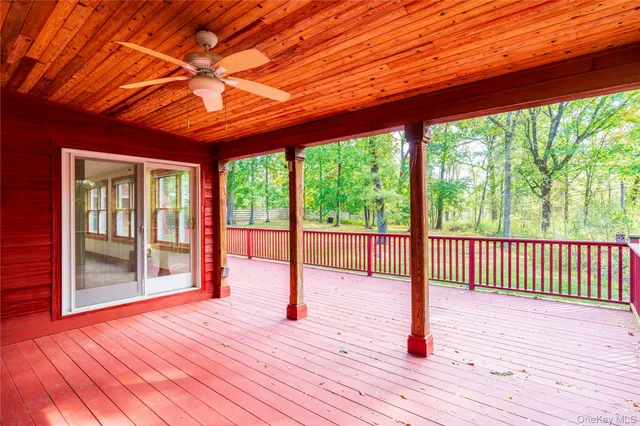 a view of backyard with a deck and wooden floor