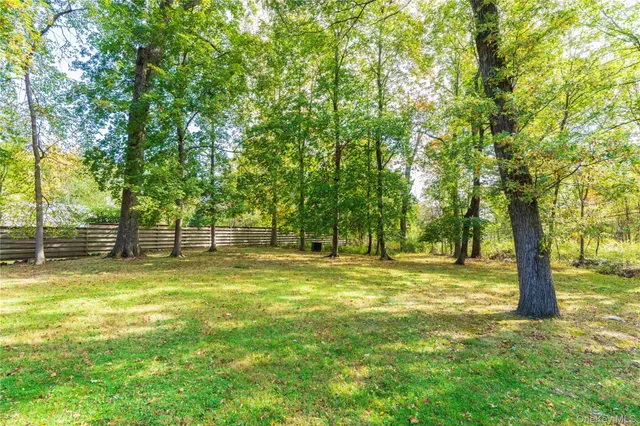 a swimming pool with trees in the background