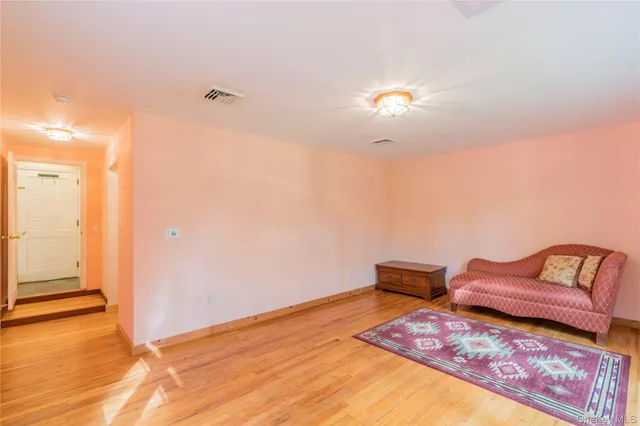 a bedroom with furniture and wooden floor