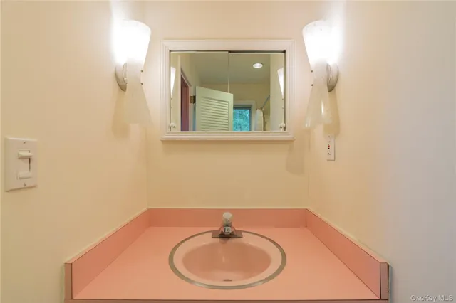 a bathroom with a sink and a mirror