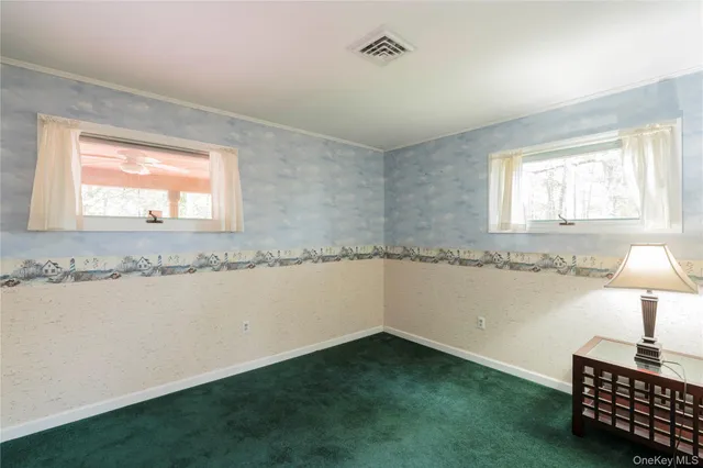 a room with a window and chandelier fan