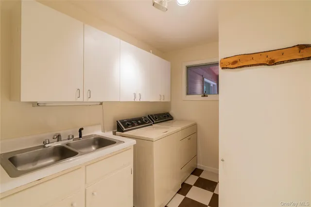 a utility room with sink dryer and washer