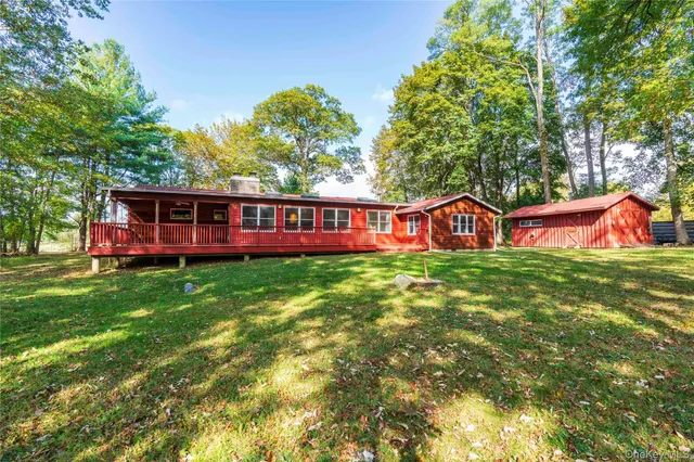 a view of a house with a yard porch and sitting area