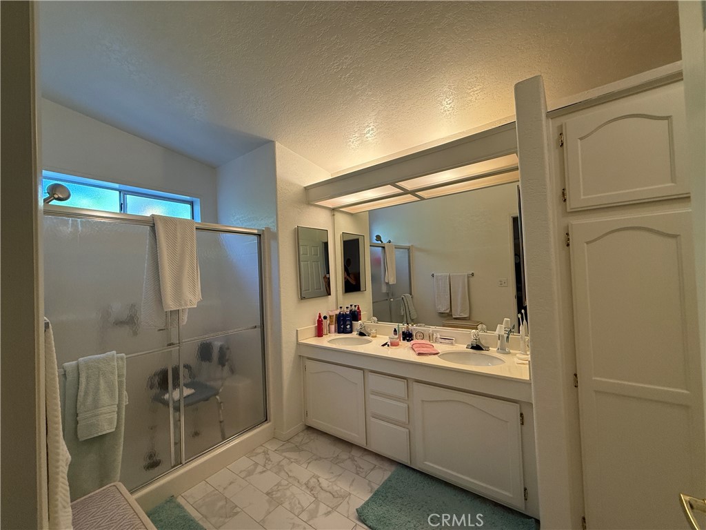 1550 Rory Lane Simi Valley, CA 93063 - Photo 14 of 18 a bathroom with a double vanity sink toilet and shower