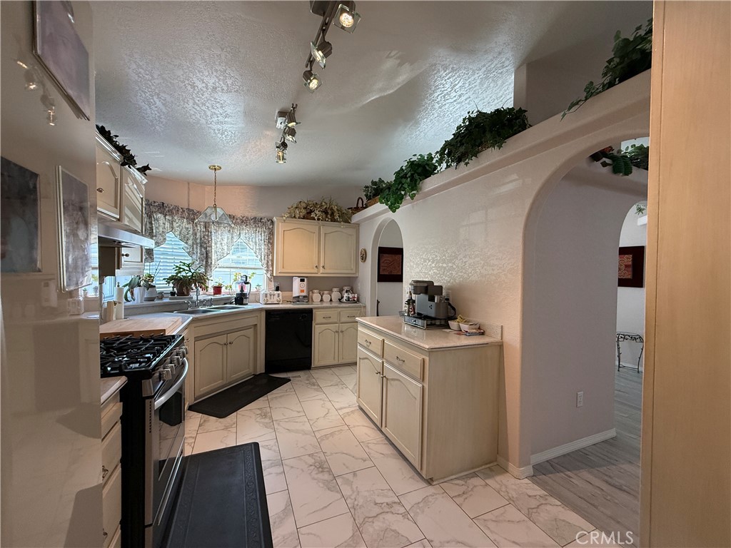 1550 Rory Lane Simi Valley, CA 93063 - Photo 4 of 18 a kitchen with granite countertop cabinets stainless steel appliances and a counter top space