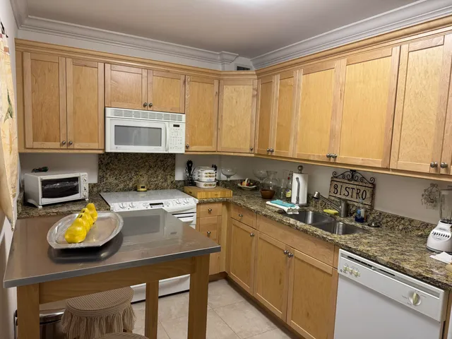 a kitchen with stainless steel appliances a refrigerator sink and stove