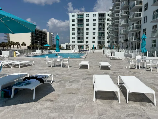 a view of a patio with swimming pool table and chairs