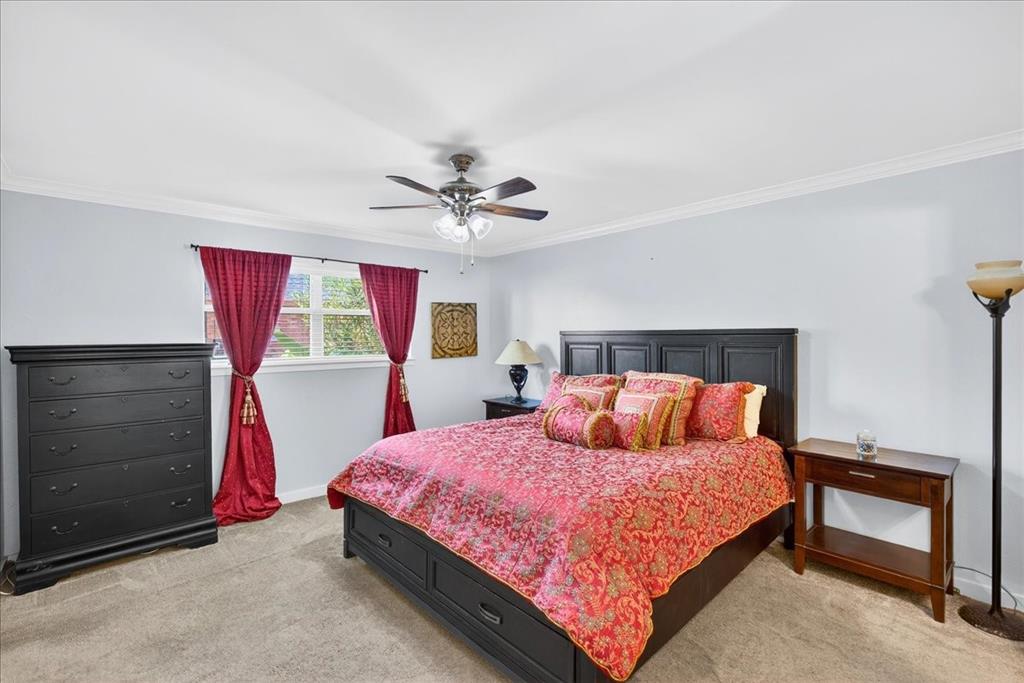 114 Baker B Ranch Road Trinidad, TX 75163 - Photo 14 of 32 a bedroom with a bed and a chandelier