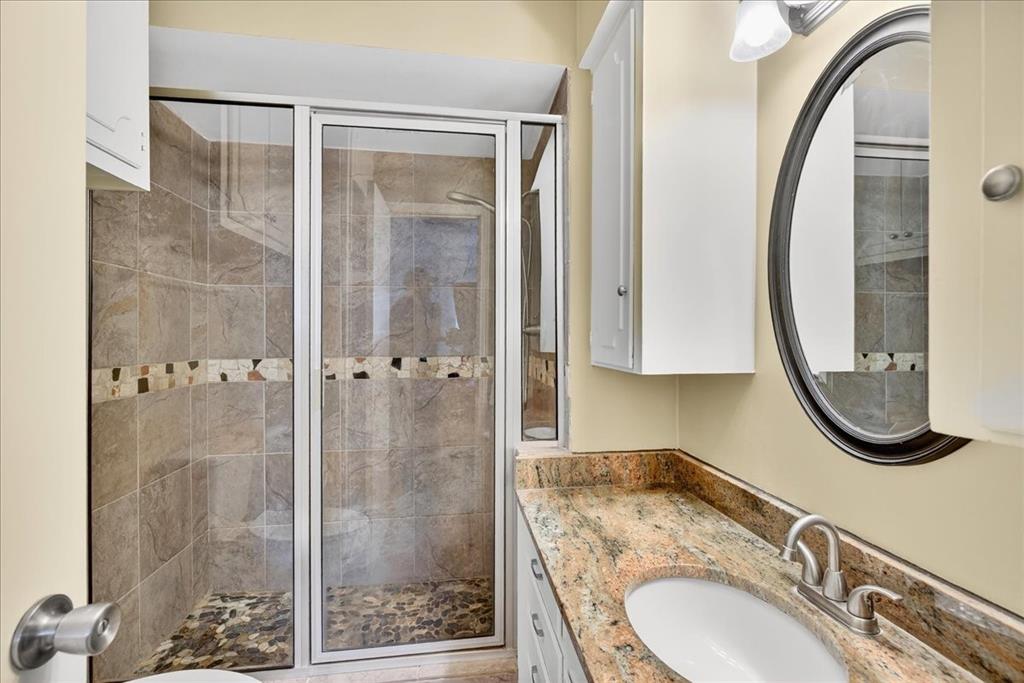 114 Baker B Ranch Road Trinidad, TX 75163 - Photo 15 of 32 a bathroom with a granite countertop sink mirror and shower