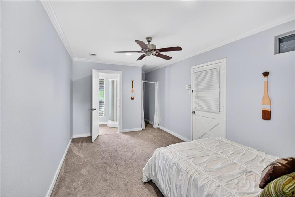 114 Baker B Ranch Road Trinidad, TX 75163 - Photo 16 of 32 a bedroom with a bed and a chandelier