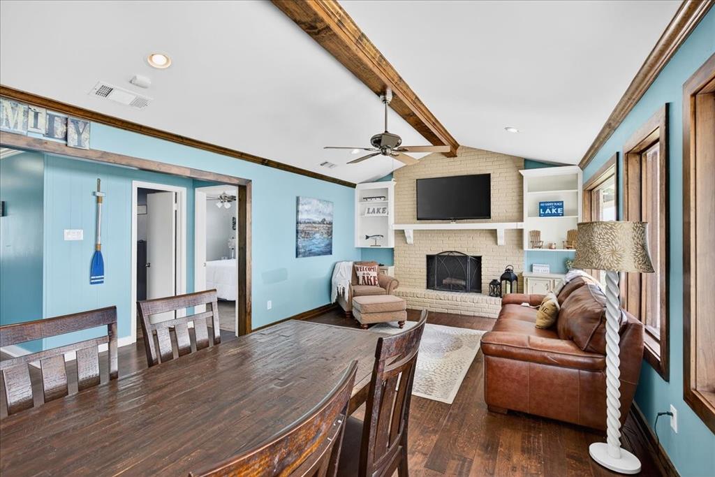 114 Baker B Ranch Road Trinidad, TX 75163 - Photo 7 of 32 a living room with furniture a fireplace and a flat screen tv