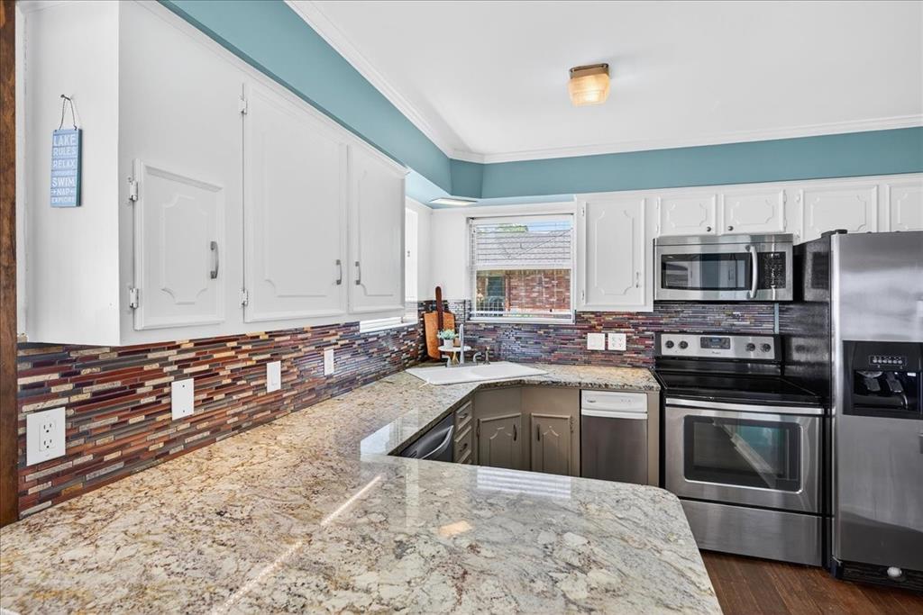 114 Baker B Ranch Road Trinidad, TX 75163 - Photo 9 of 32 a kitchen with granite countertop a sink stainless steel appliances and cabinets