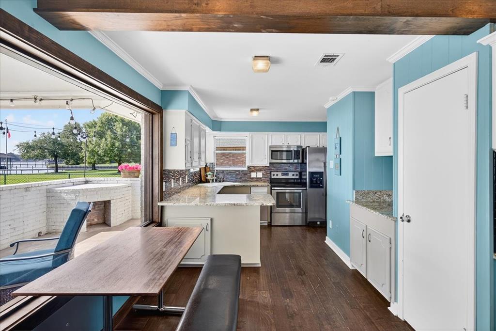 114 Baker B Ranch Road Trinidad, TX 75163 - Photo 10 of 32 a kitchen with a table chairs refrigerator and cabinets