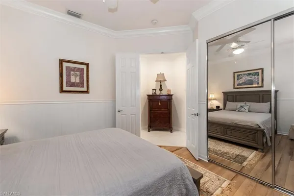 a bedroom with a bed and a painting on the wall