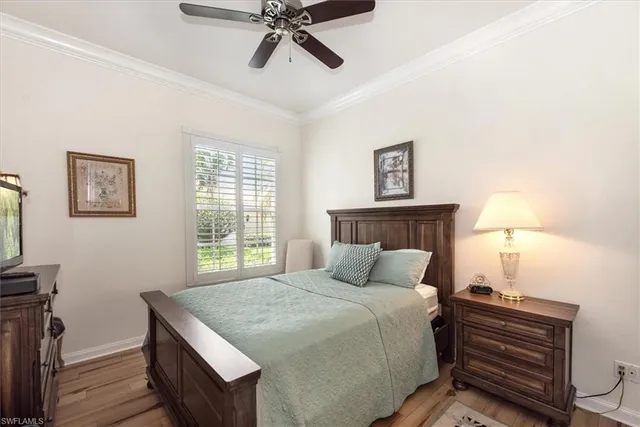 a bedroom with a bed and a flat tv screen on a dresser
