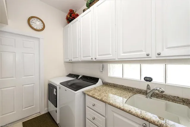 a kitchen with granite countertop a sink and cabinets
