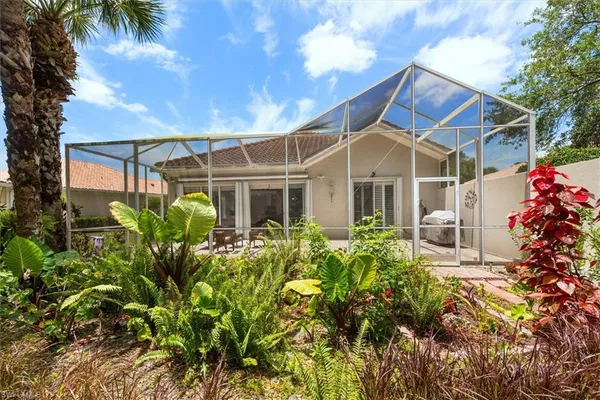 a view of a house with a flower garden