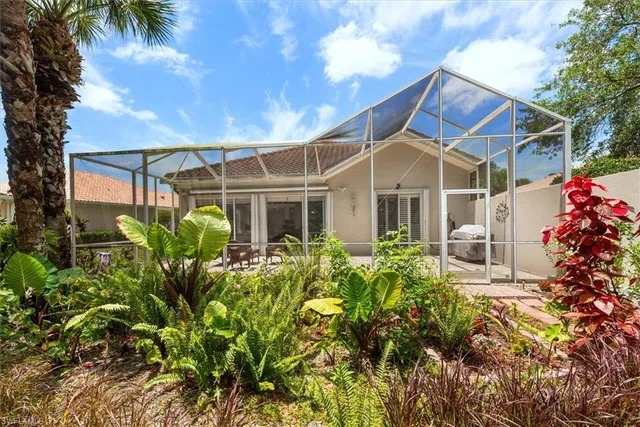 a view of a house with a flower garden