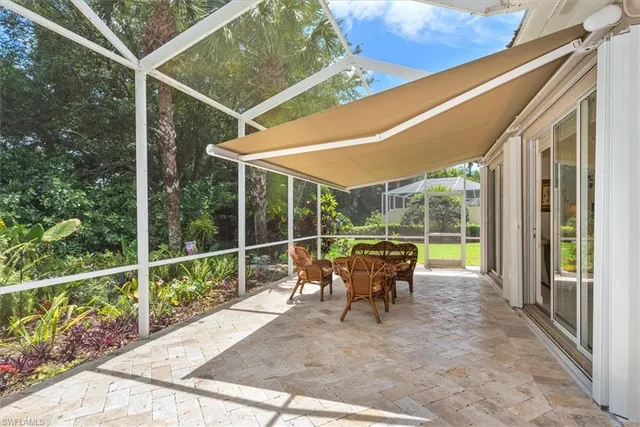 a view of a chair and tables in the balcony