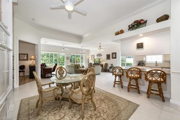 a dining room with furniture a rug and a chandelier