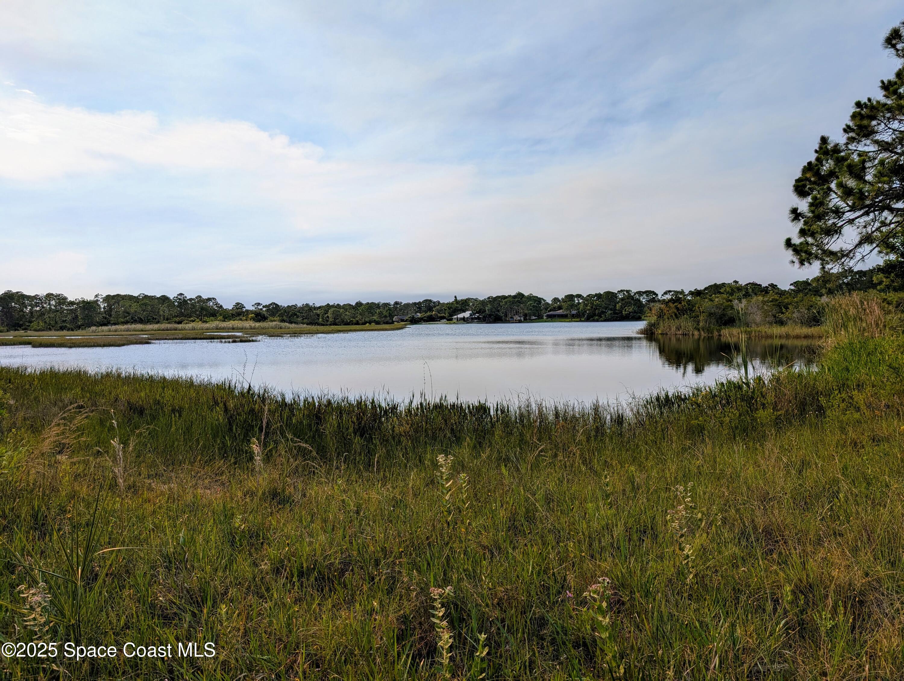 0 Unknown Road Grant, FL 32949 - Photo 3 of 36 a view of a lake with houses in the back