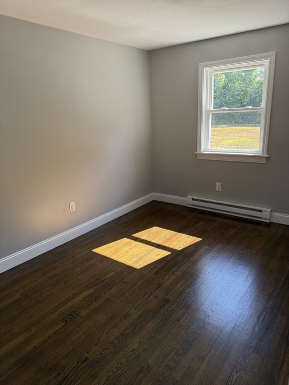 15 Washington Street, Unit 9 Plainville, MA 02762 - Photo 11 of 11 an empty room with wooden floor and windows