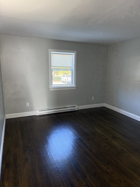 15 Washington Street, Unit 9 Plainville, MA 02762 - Photo 8 of 11 a view of an empty room with wooden floor and a window