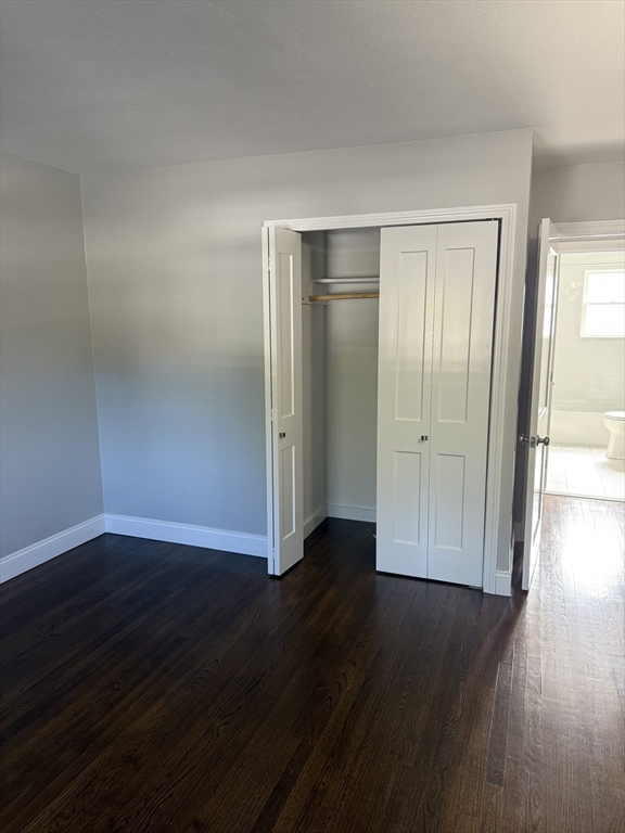 15 Washington Street, Unit 9 Plainville, MA 02762 - Photo 9 of 11 a view of empty room with wooden floor and closet