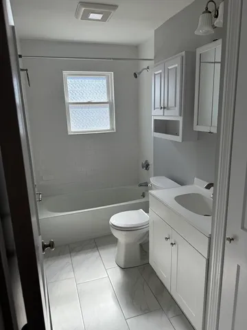 a bathroom with a toilet a sink and bathtub