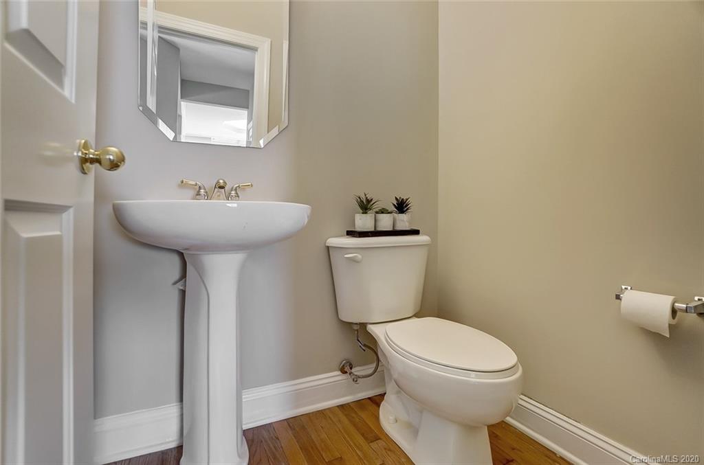 14010 Wild Elm Road Charlotte, NC 28277 - Photo 18 of 36 a bathroom with a toilet sink and mirror